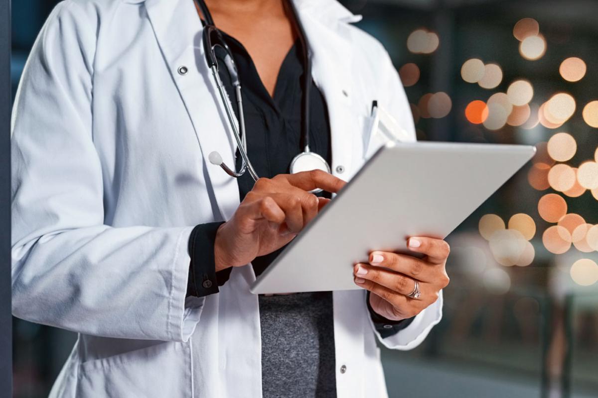 Physician working on a tablet.