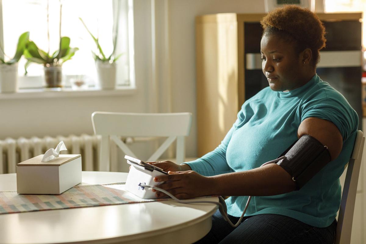 Person checking their blood pressure at home