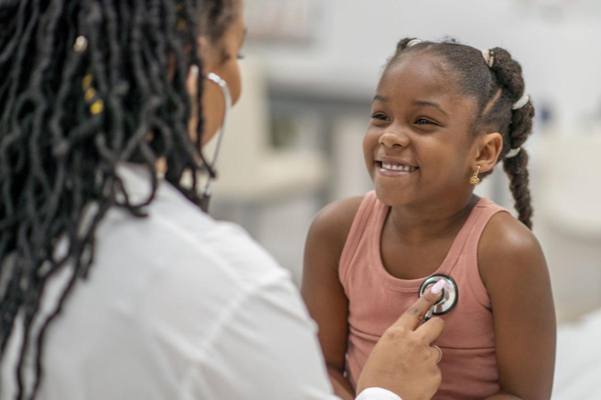 Doctor examining a smiling young patient