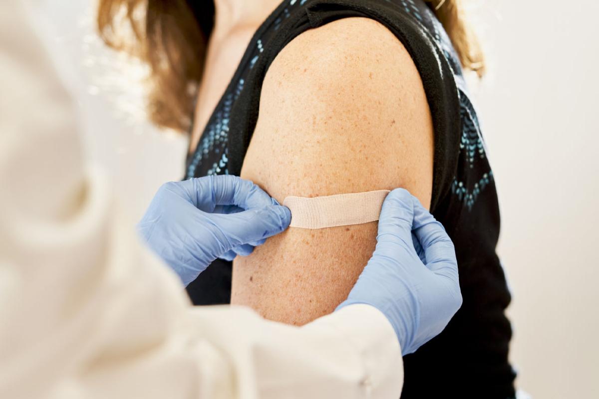 Adhesive bandage is applied to a patient's upper arm
