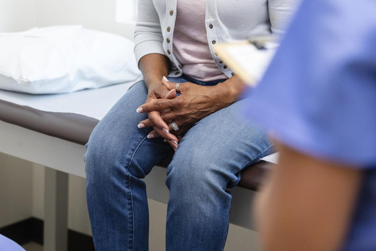 Woman patient with clasped hands