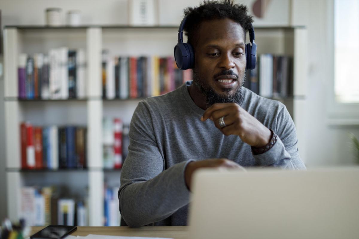 Person wearing headphones working in front of laptop
