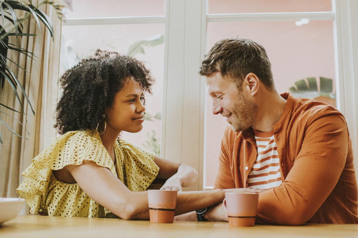 Smiling couple sits at a table