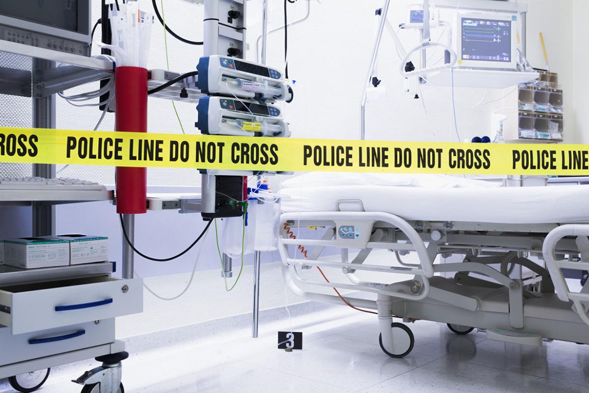 Empty hospital room with police line do not cross