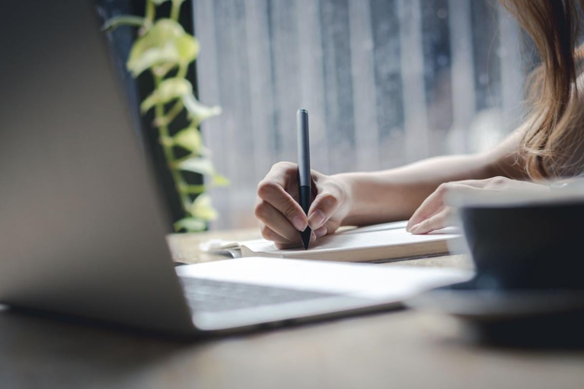 Person studies in front of a laptop