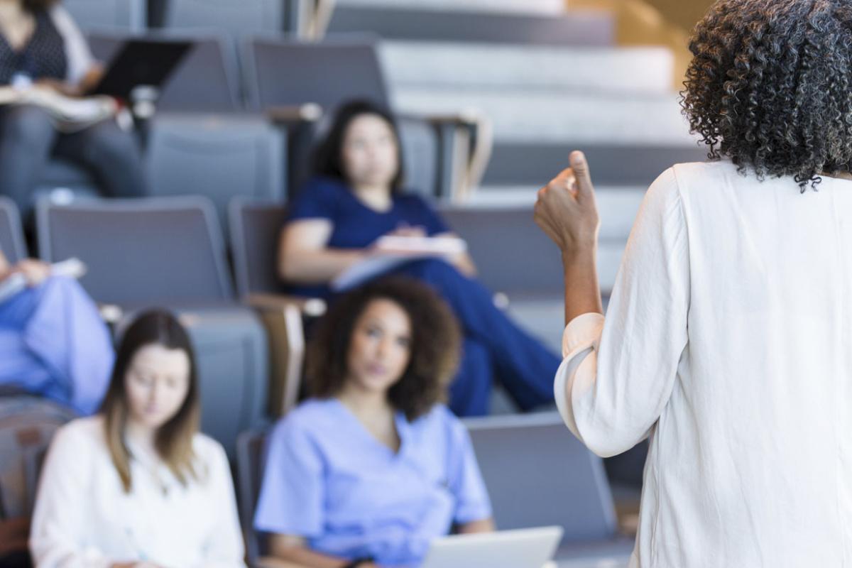 Person lectures in front of a class of students