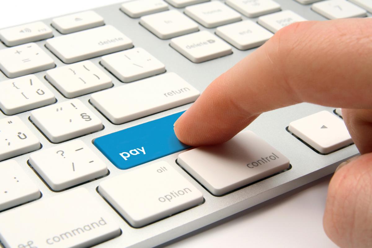 Computer keys with highlighted pay button (tight shot)