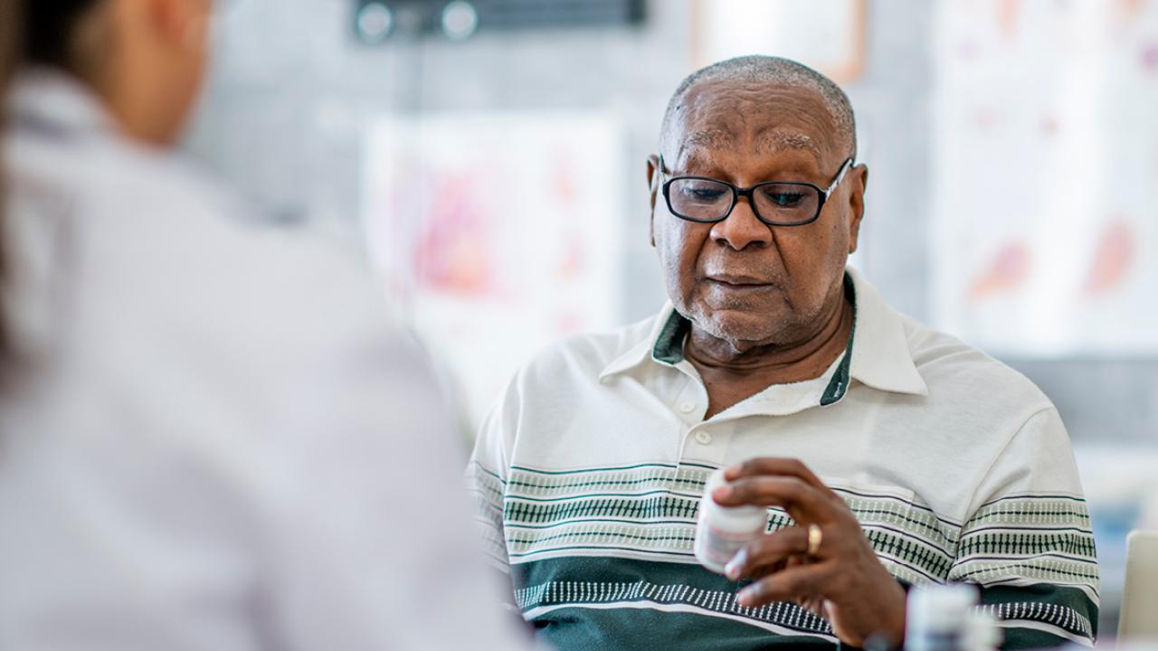 Patient looking at medicine bottle
