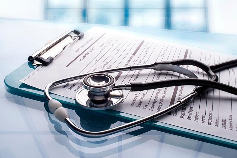 Stethoscope sitting on a clipboard with form attached