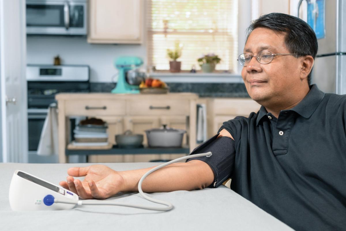 SMBP overview image of a man in glasses testing his blood pressure