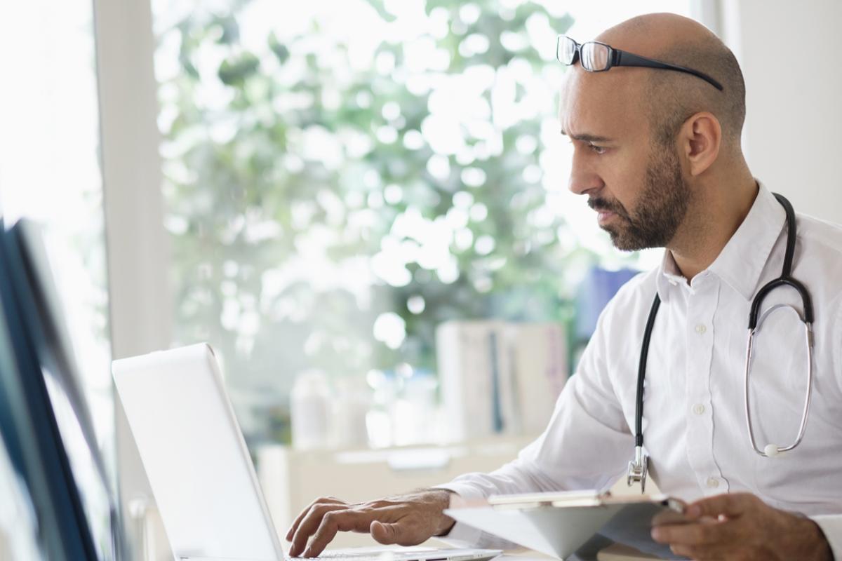 Why We Fight Prior Auth pillar: Physician looking at a computer screen