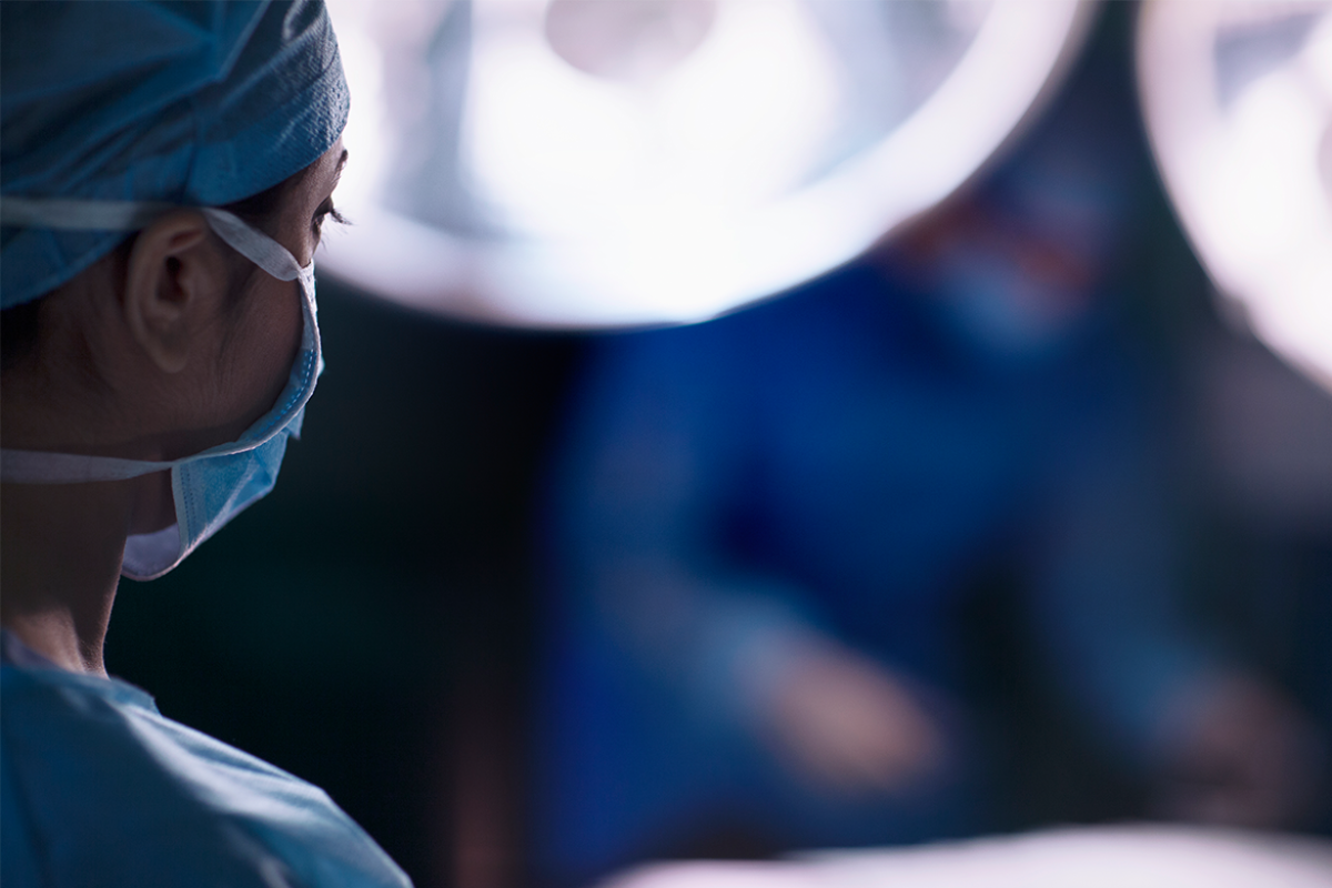Doctor looking at surgical table in operating room
